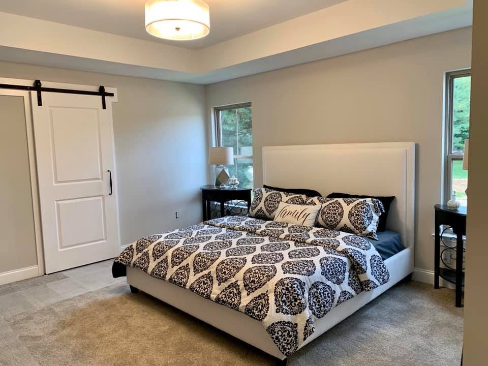 Vacant staging, Brookshire new build: primary bedroom staged beside a barn door