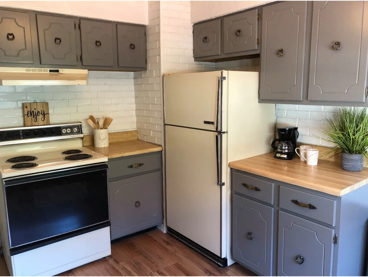 After: kitchen cabinets repainted grey with butcher block counters