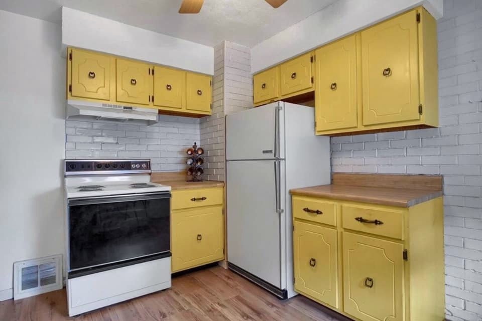 Before: the same kitchen with its original yellow cabinets