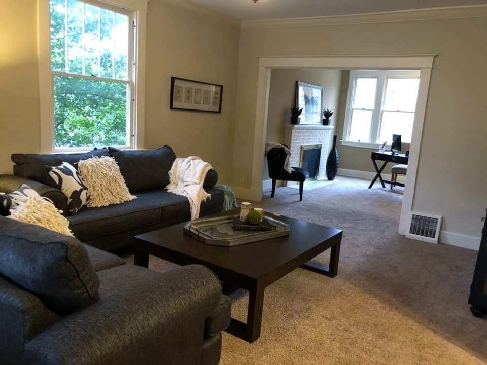 Occupied staging in downtown Edwardsville: living room opened up toward the fireplace