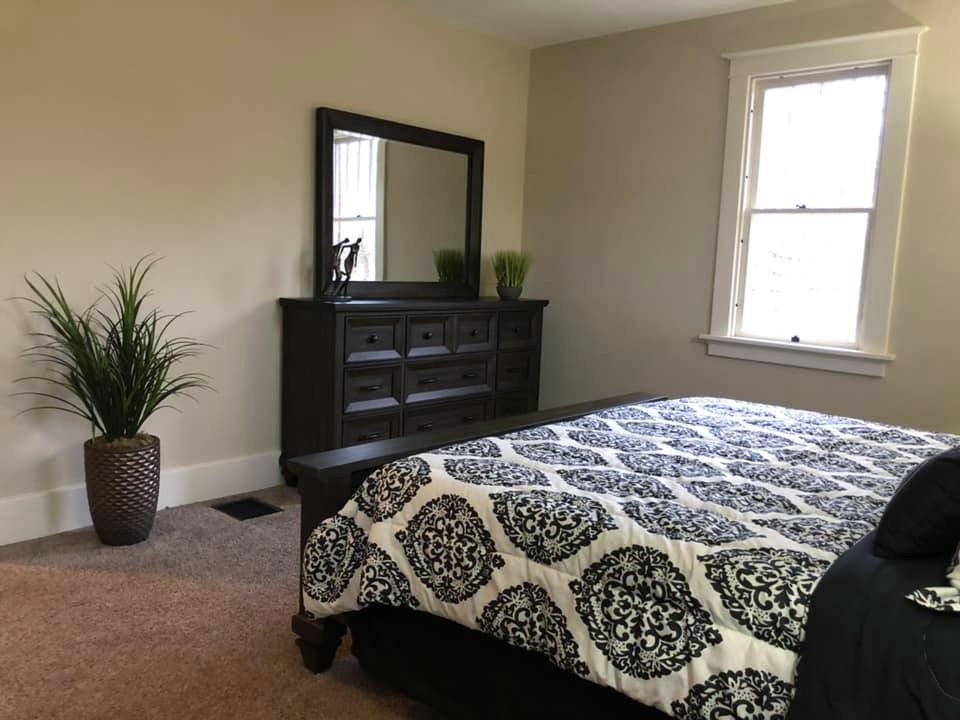 Occupied staging in downtown Edwardsville: bedroom staged with layered bedding